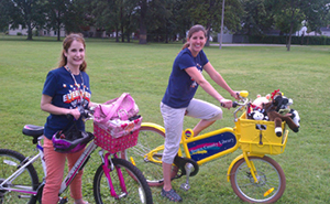 Brown County Library Children’s Librarian Katie Guzek and Library Associate Angela Zuidmulder take the BCL Book Bike to a local park.