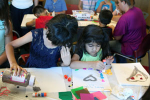 Two sisters hard at work at the collage station