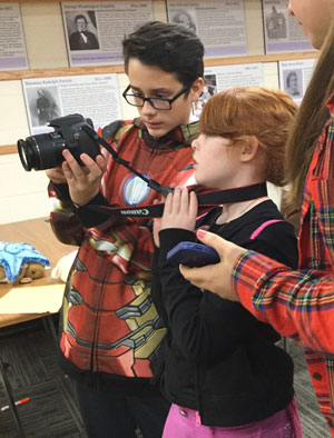 Two film lab participants looking at recently taken photo