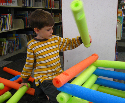 Building with pool noodle “Lincoln Logs.”