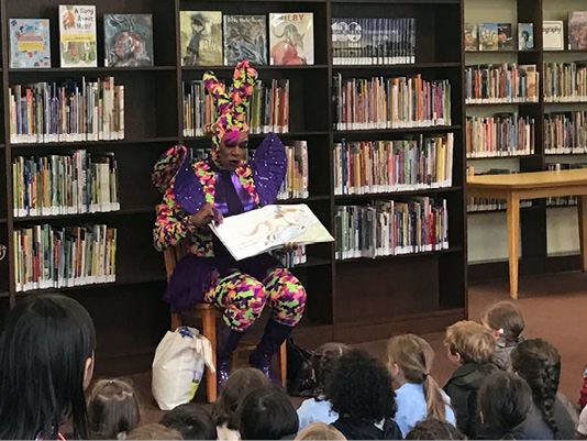 Drag Queen Harmonica Sunbeam reads to pre-K students at Hudson Park Library in New York.