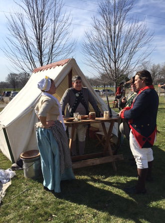Revolutionary War re-enactors set up camp outside the Kress Family Branch Library in De Pere, Wisconsin