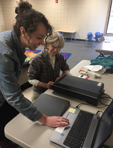 The author assists a patron during a program on digitizing photos.