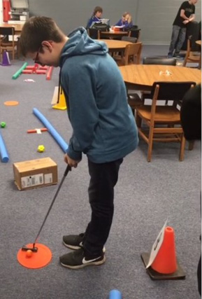 To celebrate National School Library Month and promote physical activity, Black Hills State University physical education students set up a mini golf course in the Spearfish High School Library.