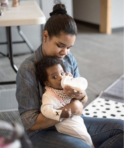 Mom Marimirca Jean-Baptiste and her infant daughter take a break at a Loud @ the Library event.