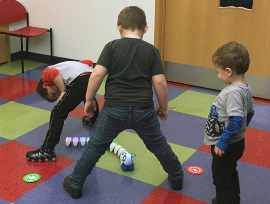 Open exploration is a great opportunity for kids to learn coding. These kids wrote the code for the Code-a-Pillar to go through their legs!