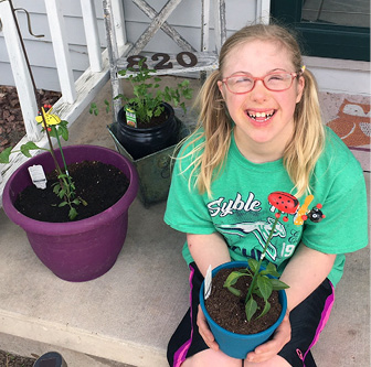 Holland Verbeten along with her vegetable seedlings—part of mom Sharon’s attempt at science class during the pandemic!