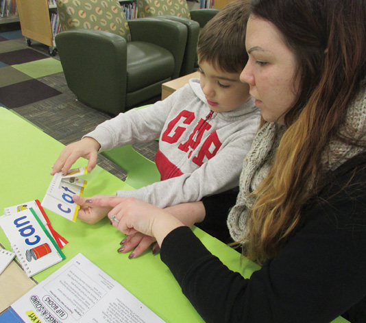 A caregiver and child enjoy sight word cards. Photo courtesy of Marybeth Kozikowski, Sachem Public Library.