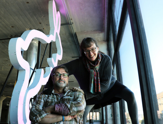 Co-founders Deb Pettid and Pete Cowdin pose with one of the giant LED bunnies that will one day adorn the roof of The Rabbit hOle, and are currently glowing in the windows on the second floor of the building.