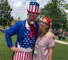 NO POLITICS HERE! In summer 2022, Miss Sharon was able to make one of her first post-pandemic outreach visits to a local park during its Independence Day celebrations. Here she was greeted by the very tall, very patriotic Uncle Sam himself! 