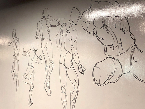 Figure 3. Human figure drawings on the whiteboard wall.